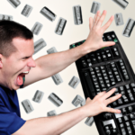 frustrated computer user throws keyboard at computer screen