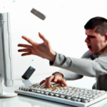 frustrated computer user throws keyboard at computer screen