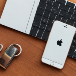 keyboard and smartphone on a desk next to a padlock