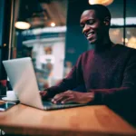 Man working on laptop in coffee shop